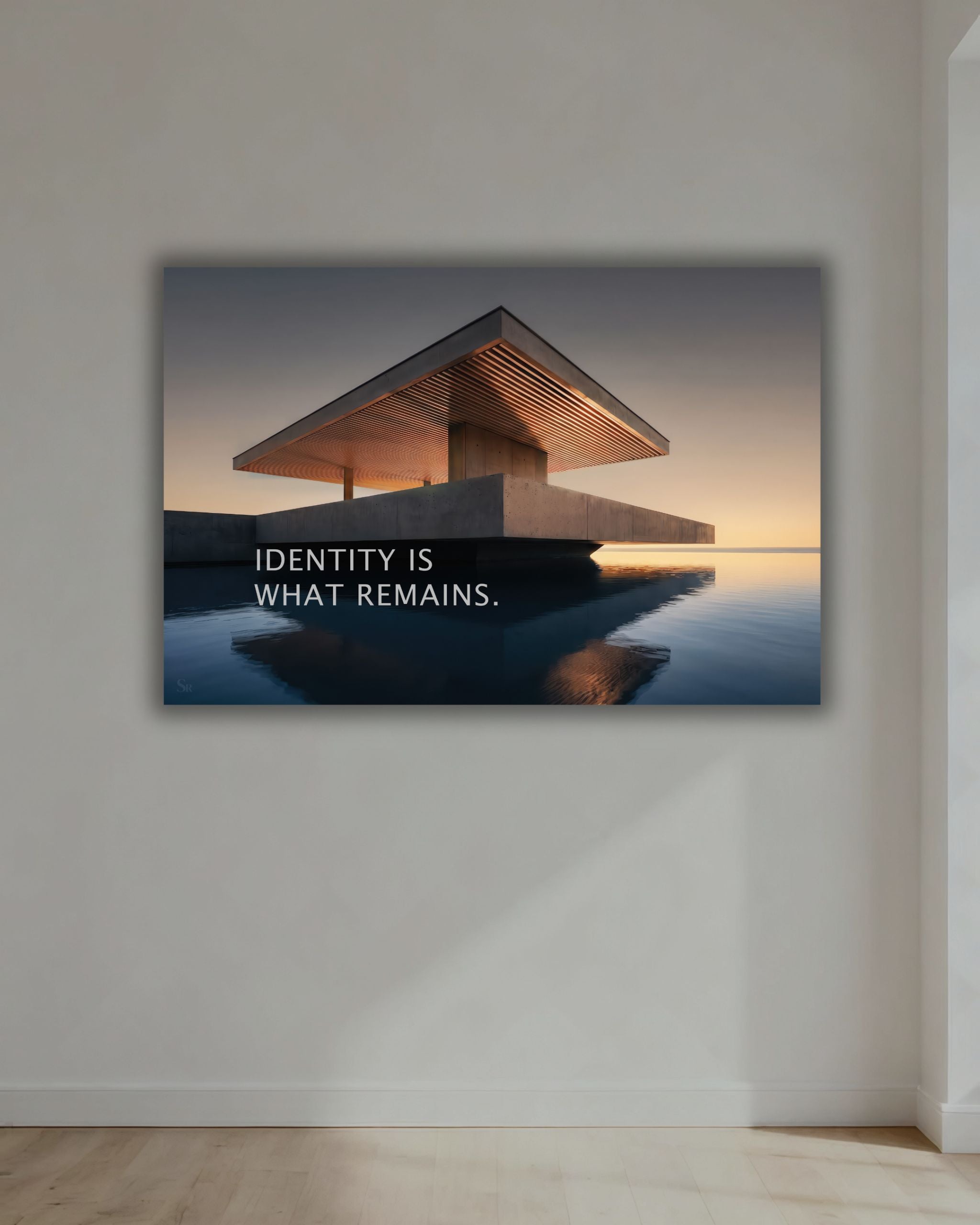 Statement Wandbild auf Alu-Dibond mit dem Statement "Identity is what remains." im Wohnbereich.