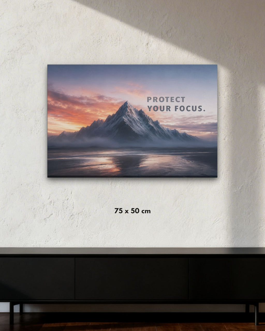 Statement-Piece „PROTECT YOUR FOCUS.“ als Leinwandbild im Raum mit Bergmotiv und klarer Fokus-Botschaft in der Größe 75x50cm